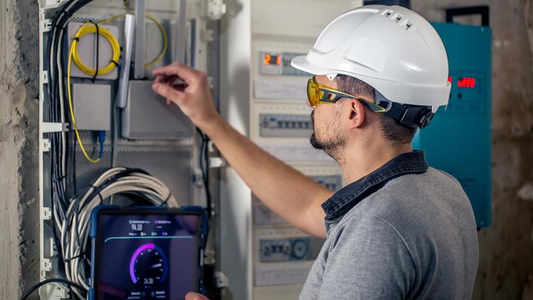 img__0000s_0005_man-electrical-technician-working-switchboard-with-fuses-uses-tablet (1)