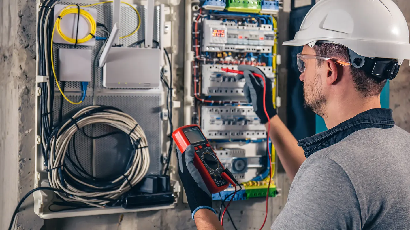 img__0000s_0006_man-electrical-technician-working-switchboard-with-fuses