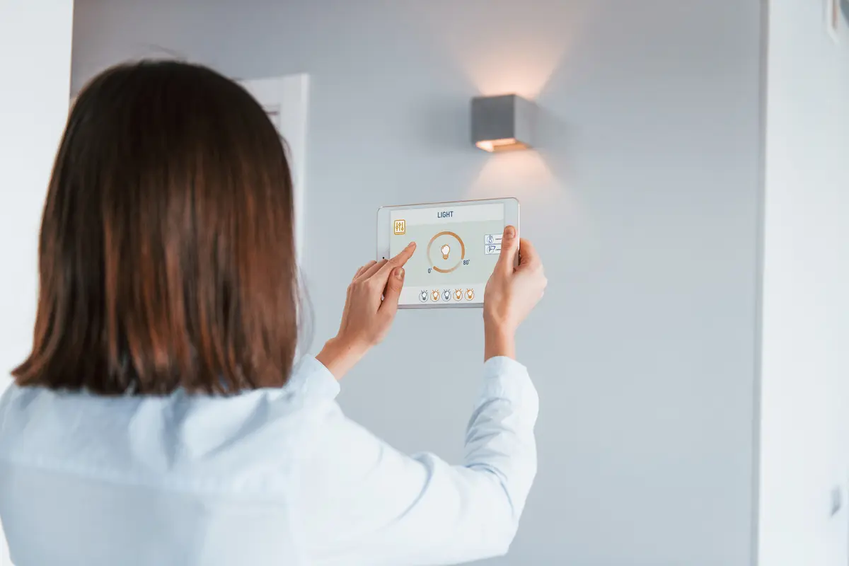 rear-view-woman-that-is-indoors-controlling-smart-home-technology